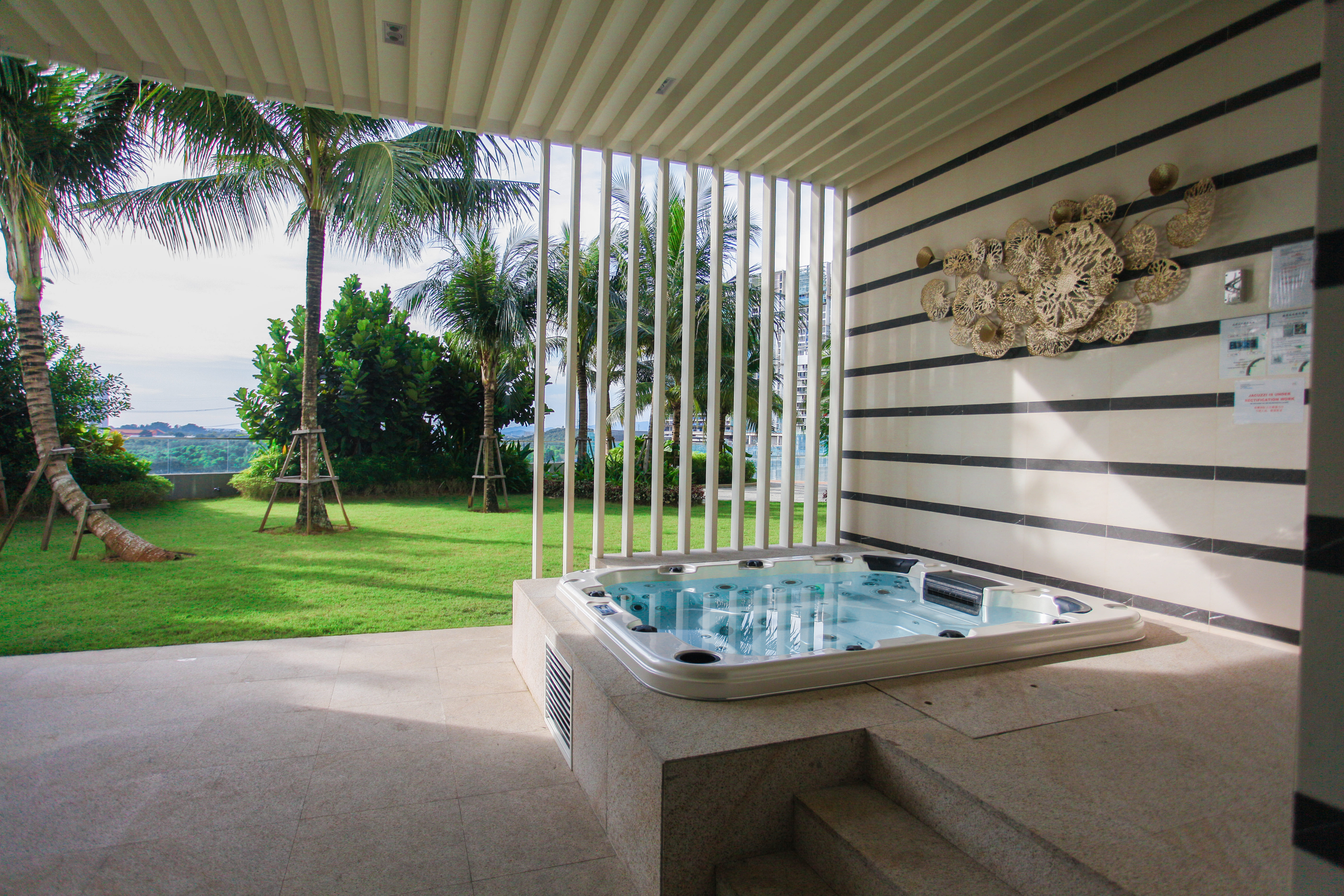 Outdoor jacuzzi with garden views at The M Macrolink