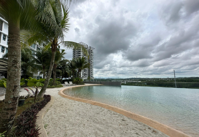 Miami beach-style pool with sandy shore at The M Macrolink